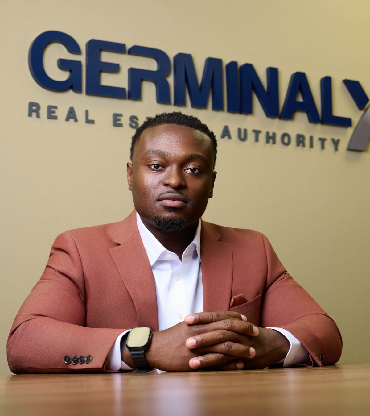 Julian Germinal seated at a table at Germinal X Real Estate Authority